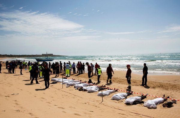 спасатели рядом с телами утонувших мигрантов